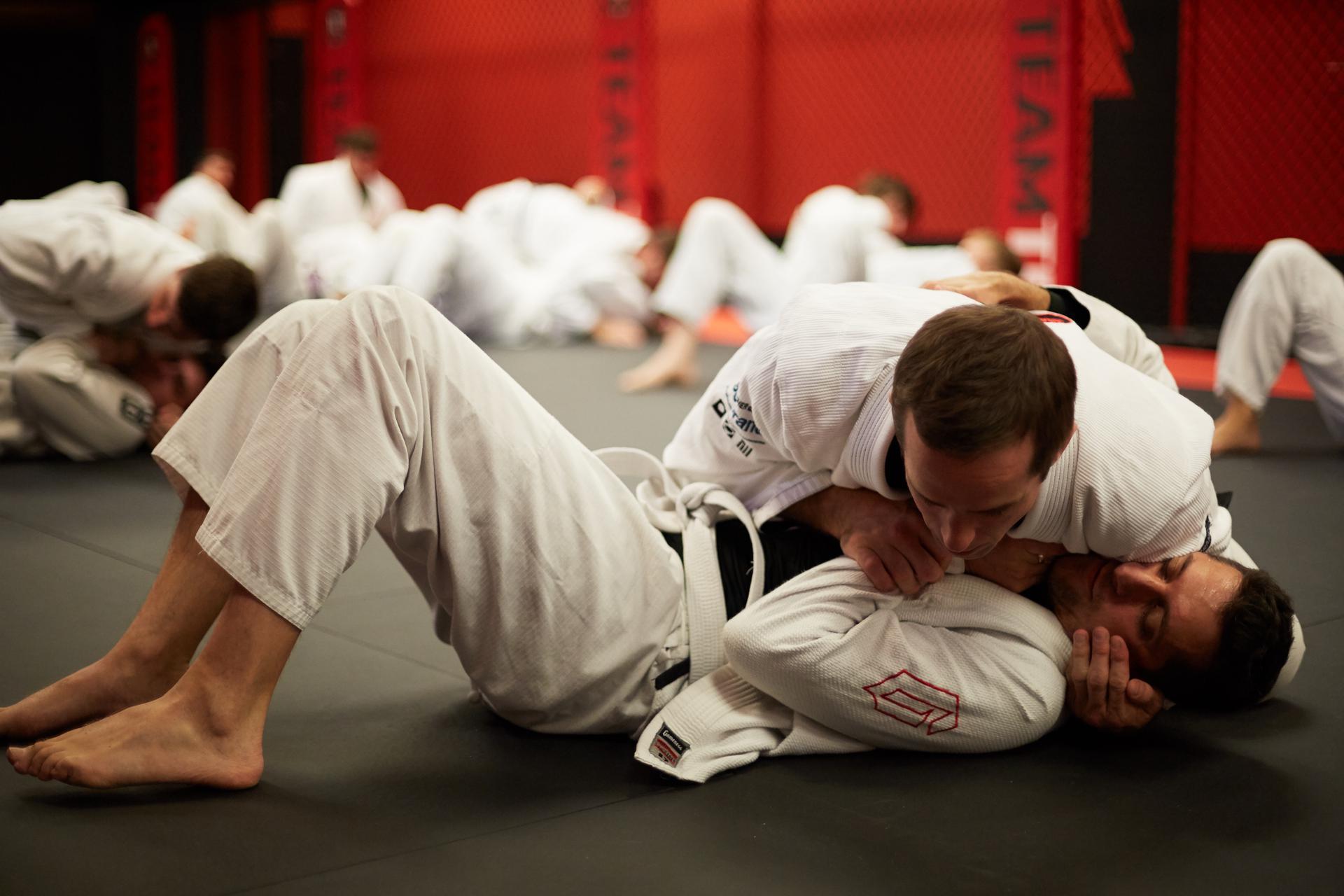 two men training in a jiu jitsu class
